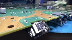 Close-up of PS5 HDMI port replacement being soldered at Tekkies electronics repair in Bartlett, Illinois